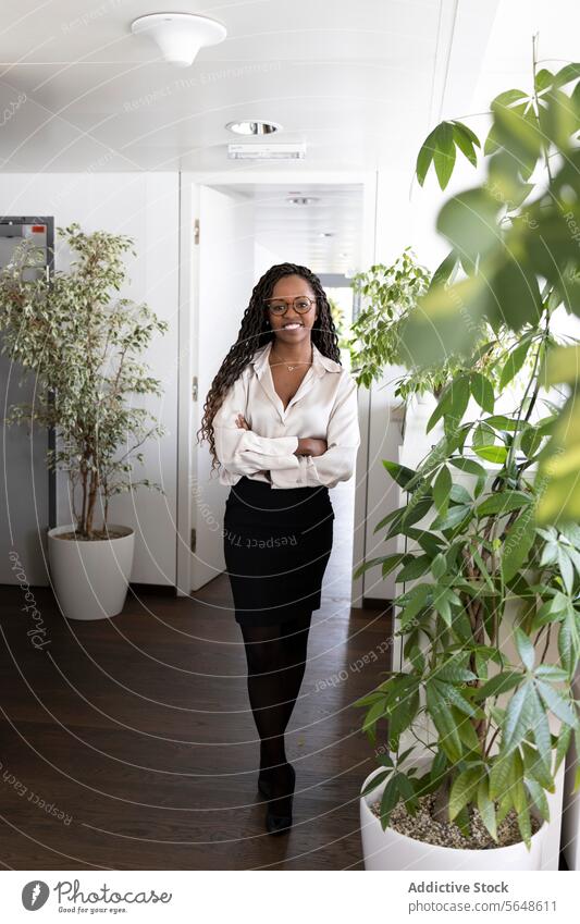 Portrait of happy black businesswoman standing arms crossed in office Businesswoman Happy Confident Success Formal Office Arms Crossed Smile Full Body Woman