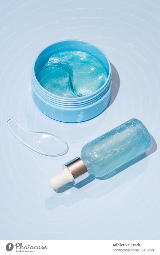 Blue Skincare Products on a Light Background skincare product blue gel jar bottle dropper pastel background cosmetic beauty top view light pastel blue container
