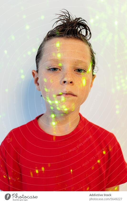 Serious boy with hairstyle looking at camera in studio with neon lights Boy Portrait Neon Light Hairstyle Confident Glow Face Studio Kid Hairdo Appearance Style