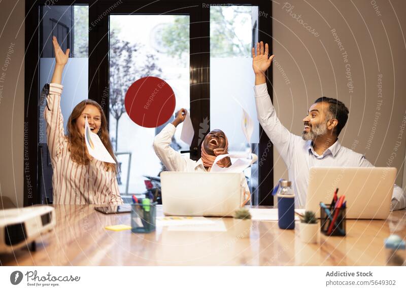Excited diverse businesspeople with laptops celebrating success in office coworker colleague smile victory celebrate pc netbook arms raised achieve win project