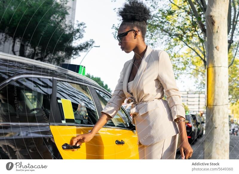 Serious black Young businesswoman getting into public transport entrepreneur taxi elegant formals open door commuter city transportation sunlight travel