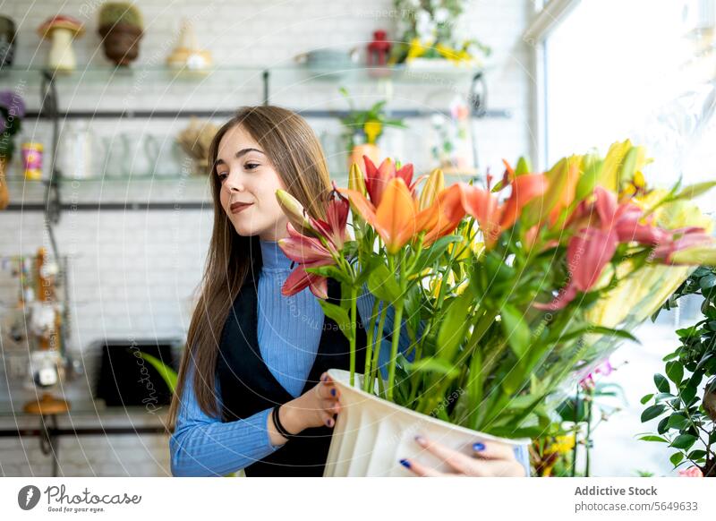 Young woman standing holding bouquet in shop tulip florist flower smile floral blossom bloom happy bunch decor style fresh plant elegant positive shelf fragrant