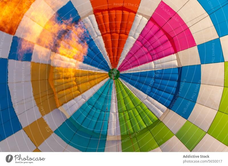 Multicolored hot air balloon flying in sky at tourist site float colorful multicolored event flight surface daytime from above closeup vivid tourism trip