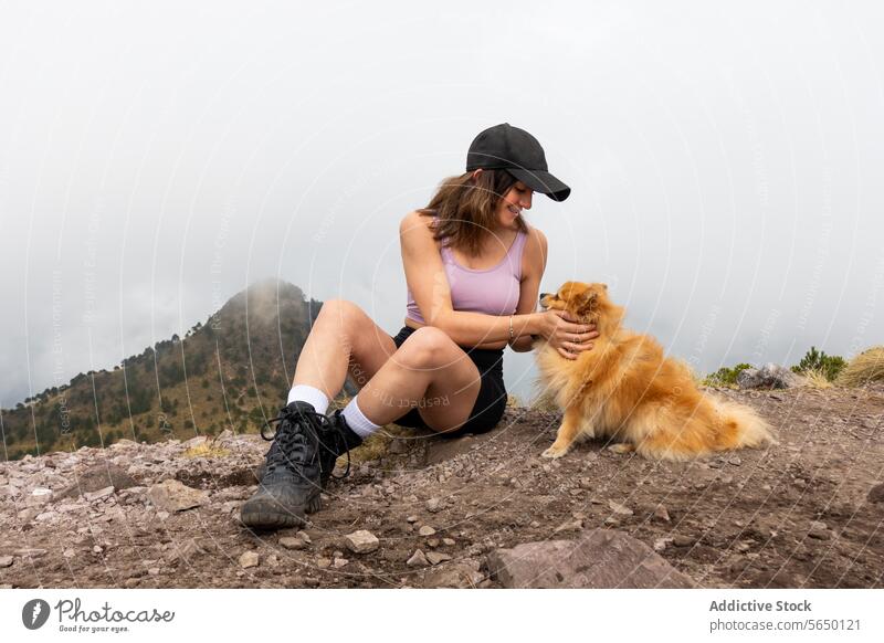 Hiker sitting with Dog in Ajusco woman Pomeranian dog hiking trail Cumbres del Ajusco national park Pico del Águila Mexico City outdoor pet nature bonding