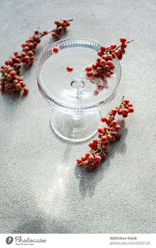 Elegant glass cake stand with scattered berries berry elegant texture surface clear adornment dessert display presentation kitchenware tableware transparent