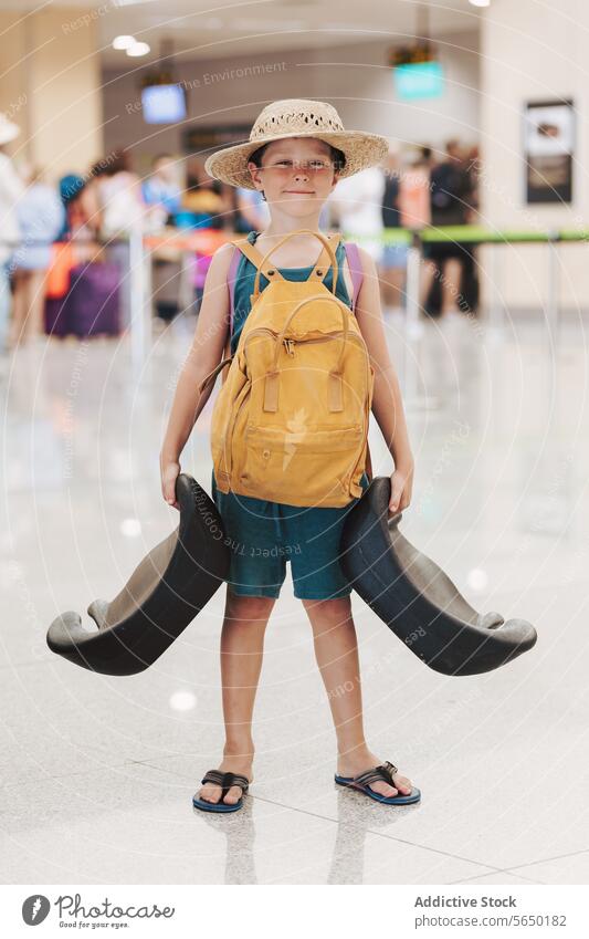 Happy Boy Holding Giant Luggage Handles boy luggage airport suitcase handle hat smile kid travel terminal passenger adventure vacation journey summer shorts