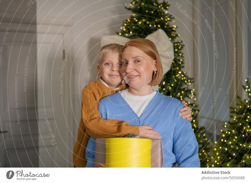 Joyful mother and son sharing a Christmas moment christmas embrace family joy festive warmth decoration tree celebration holiday together love togetherness