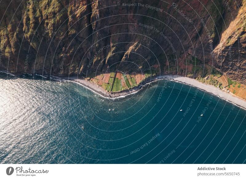 Drone view of coastline with field and mountain sea farmland foothill nature sunny blue boat water travel village sunlight cliff beautiful scenery rock