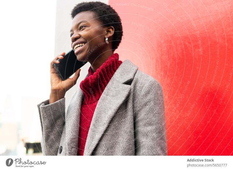 Cheerful African American woman talking on smartphone on street phone call cellphone using speak communicate chat female style smile happy african american
