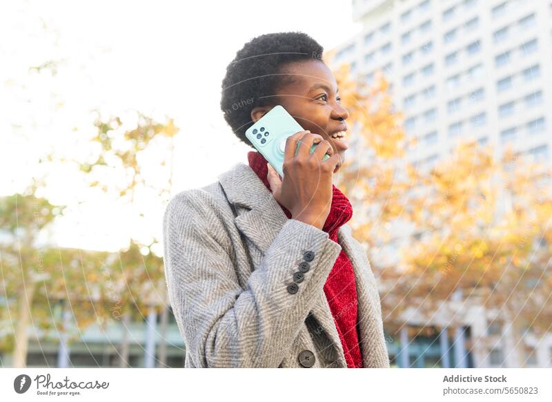Smiling African American woman talking on smartphone in street using cellphone speak city smile mobile phone surfing happy modern positive online internet chat