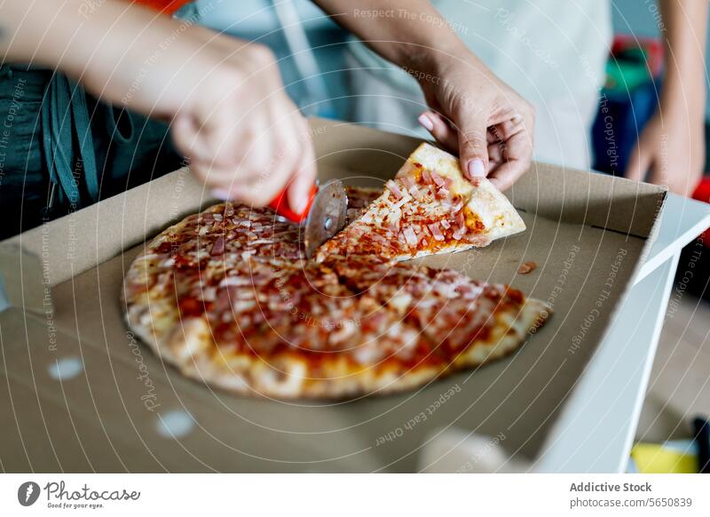 Hand cutting piece of appetizing pizza in open box hand cutter yummy tantalizing anonymous person eat food delicious lunch tasty dish snack fresh slice meal