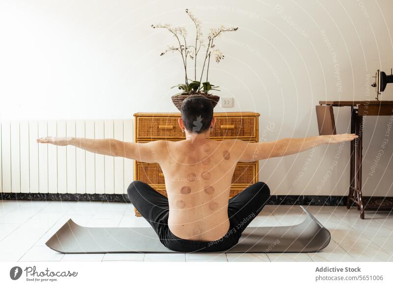 Faceless man stretching arms sideways during fitness workout rehabilitation exercise training muscular outstretch shirtless yoga practice strength balance