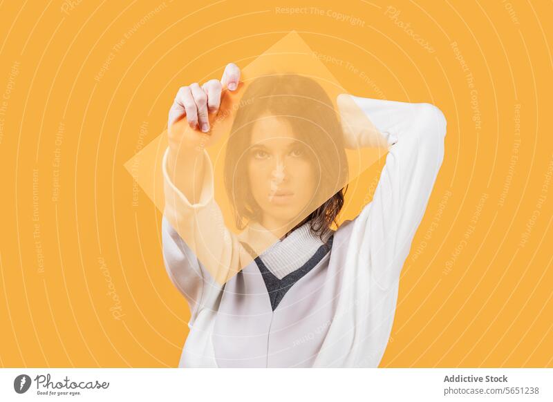 Woman in warm casual attire holding transparent plastic woman trendy purple sweater isolated copy space advertisement style showing yellow background short hair