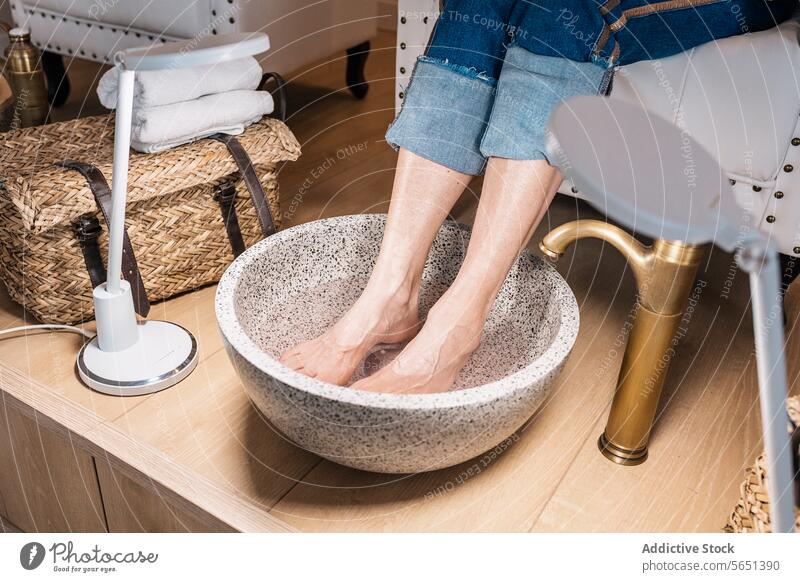 Woman getting warmed by footbath at beauty salon woman pedicure feet water spa relax bowl dip enjoy barefoot wellness treat cosmetic fresh female pamper