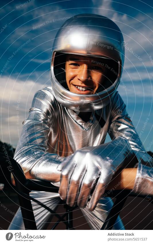 Young man sitting on bicycle in helmet in light stuntman biker ride confident costume glove sunset countryside male young rider cloudy style vehicle handlebar