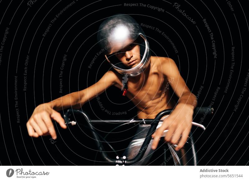 Unrecognizable young man sitting on bicycle shirtless in lights helmet cyclist handlebar protect vehicle safety ground male bike transport biker hobby style