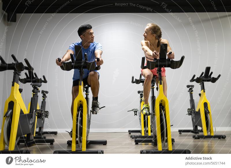 Indoor cycling session with focused participants indoor fitness gym workout stationary bike exercise sport health intense training people physical activity