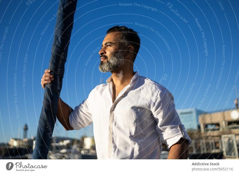Smiling man taking selfie while standing on yacht in sea phone using beard travel relax trip boat vessel nature seascape seaside modern coast ship shore