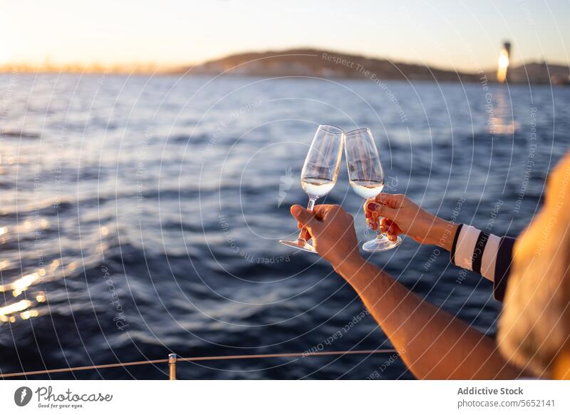 Anonymous couple clinking wineglasses in yacht against sea love romantic toast ocean beach alcohol date resort drink cheers enjoy pleasure seascape romance