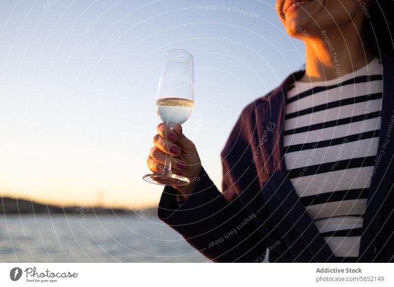 Unrecognizable young woman with glass of drink standing against sea water ocean yacht outfit sailboat shore tourism idyllic modern aqua ripple coast clear