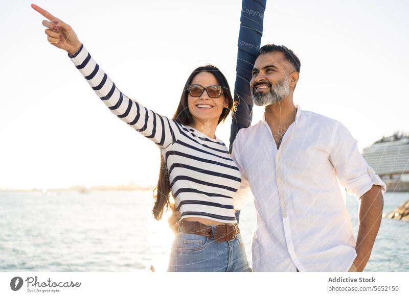 Happy couple standing on seafront trip travel yacht romantic love enjoy happy point tourism modern boat positive journey coast smile marine water girlfriend