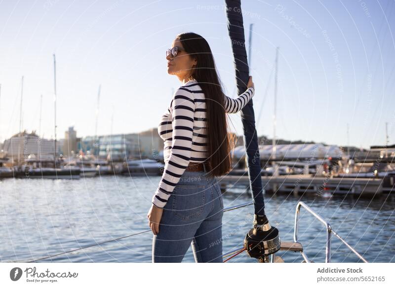 Serious young woman standing on yacht serious sea float seascape boat water vessel casual seafront seawater travel enjoy sunglasses river ocean skyline trip