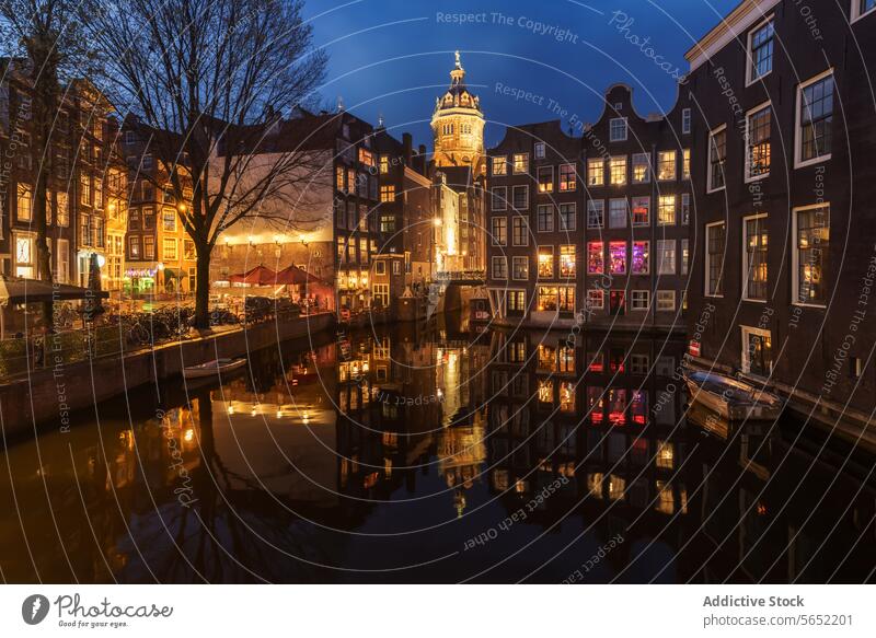 Night falls over the illuminated Amsterdam canals, creating a picturesque scene with the city's vibrant architecture night city architecture Netherlands urban