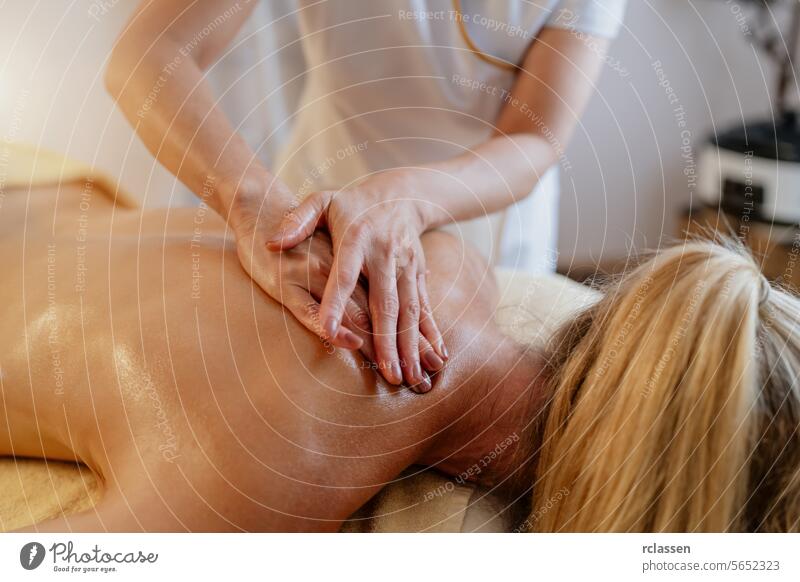 Close-up of a massage therapist's hands applying pressure on a client's back. beauty salon Wellness Hotel Concept image massage therapy back pressure relaxation