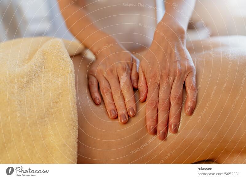 Close-up of hands performing a back massage on a client covered with a towel. beauty salon Wellness Hotel Concept image hotel close-up relaxation therapy