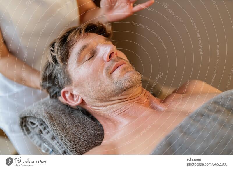 Relaxed man receiving a neck massage from a therapist with blurred hands physiotherapist hotel massage oils asian man relaxing relaxation therapist's hands