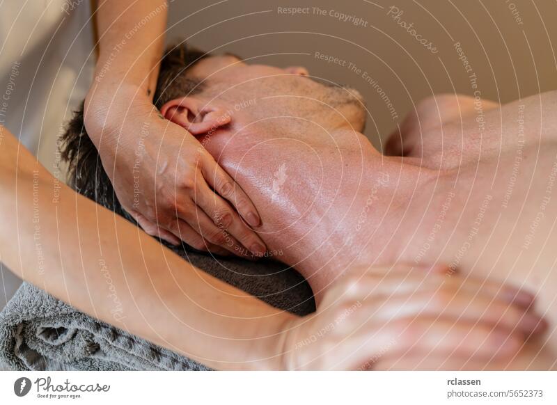 Close-up of a male receiving a detailed neck massage from a therapist. Wellness Hotel Concept image. hotel massage oils clinic asian relaxation