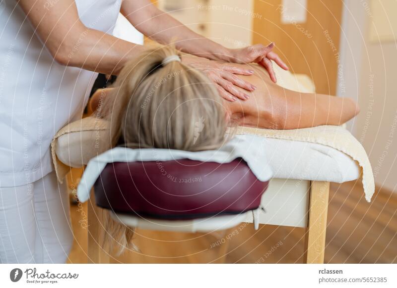Massage therapist treating a female client’s back at a wellness spa. beauty salon Wellness Hotel Concept image pressure point back massage hands relaxation