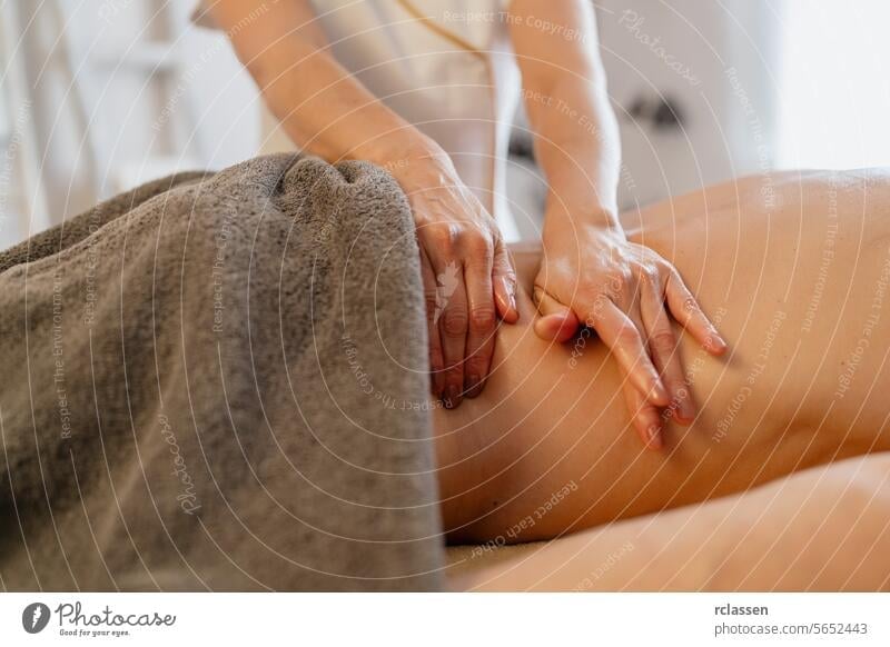 Close-up of a therapist's hands performing a back massage on a covered client beauty salon massage oils physiotherapist shoulder massage relaxation