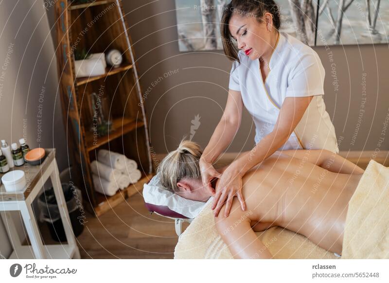 Asian Massage therapist giving back massage to female client in spa setting. beauty salon Wellness Hotel Concept image hotel asian massage therapy relaxation