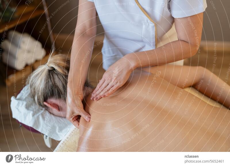 Close-up of hands performing a back massage on a woman at a spa resort hotel massage oils asian beauty salon massage therapy relaxation wellness female client