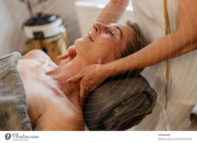 Woman receiving a relaxing neck massage at a spa with a therapist's hands on her shoulder. beauty salon Wellness Hotel Concept image physiotherapist clinic