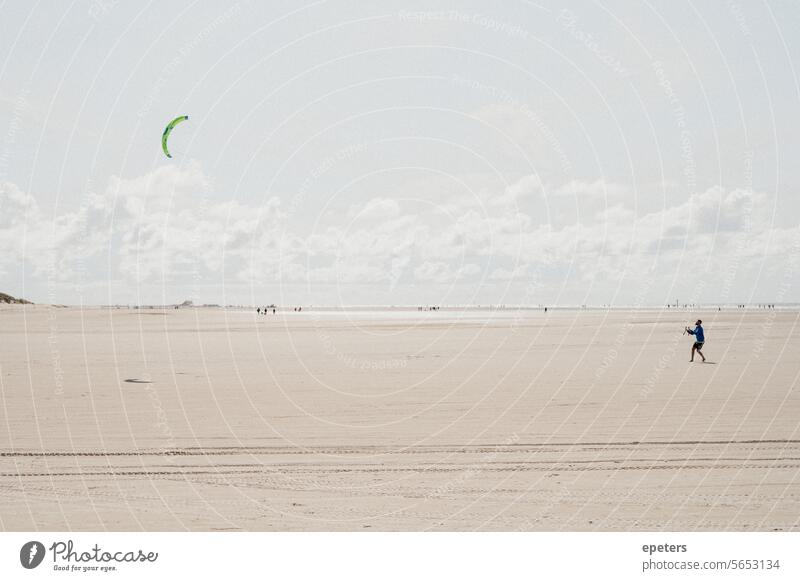 Man flies a stunt kite on the beach at Sankt Peter-Ording hang gliders wind kites Flying Hang gliding Hope Ease Freedom symbol Sky Playing Dragon