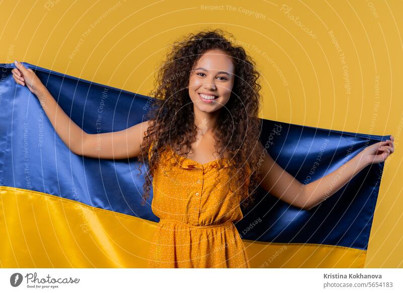 Woman with national Ukrainian flag. Ukraine, patriot, victory war celebration banner beautiful celebrating cheerful clever culture curly haired east europe