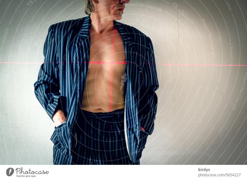 Man with suit and bare chest in the sights of a laser Suit Looking away Laser laser cross targeted Heart in sight Naked flesh Upper body Masculine Slim