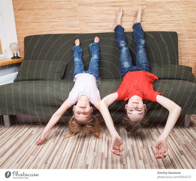 Siblings losing they mind confined at home during self-isolation boy brother candid carefree casual child childhood children confinement contain containment