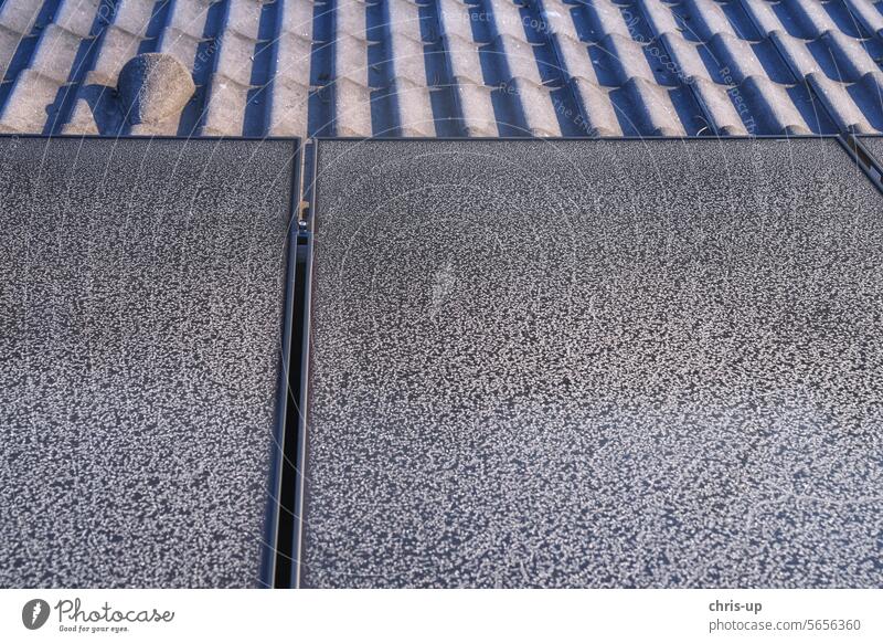 Frost pattern on photovoltaic modules on a cold sunny day in winter frost solar frost pattern renewable energy transition solar module solar panel