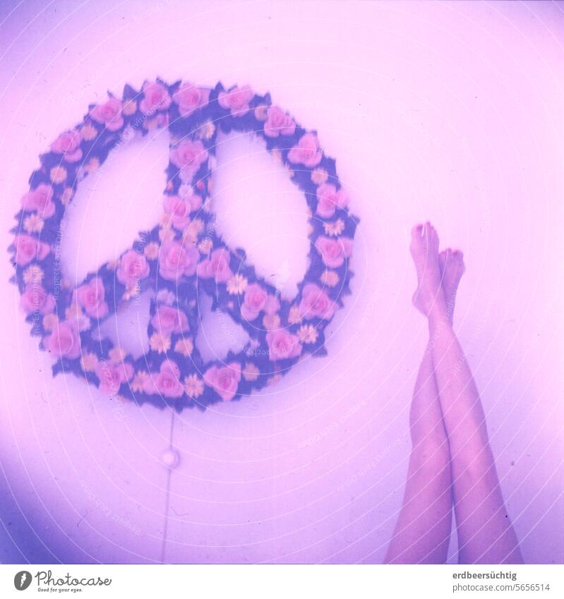 Peace and legs - Peace sign wall lamp and outstretched female legs in dull colors and with a blue tint peace sign Love Legs Slim blossoms Artificial flowers