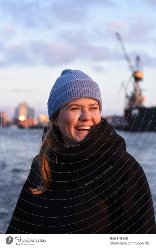 JOY - LAUGHTER - HAMBURG Woman 18 - 30 years Laughter cute Cap Blue Hamburg Elbe Philharmonic Hall Water Sunset Harbour Colour photo Port City Exterior shot