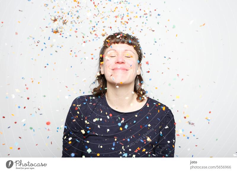 Colorful confetti rains over young, smiling woman Confetti showery with confetti variegated Party Party mood Party goer Feasts & Celebrations Birthday fortunate
