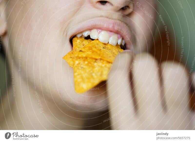 Crop anonymous girl biting yummy crunchy Mexican tortilla chips Girl Eat Tortilla Chip Delicious Crunch Bite Mouth Open Crispy Unhealthy Nachos Snack Fried