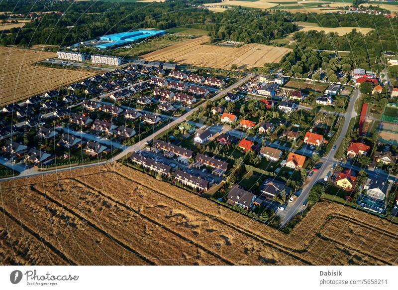 Residential houses in small town near agricultural field, aerial view suburban building real estate residential district city neighborhood townhouse village