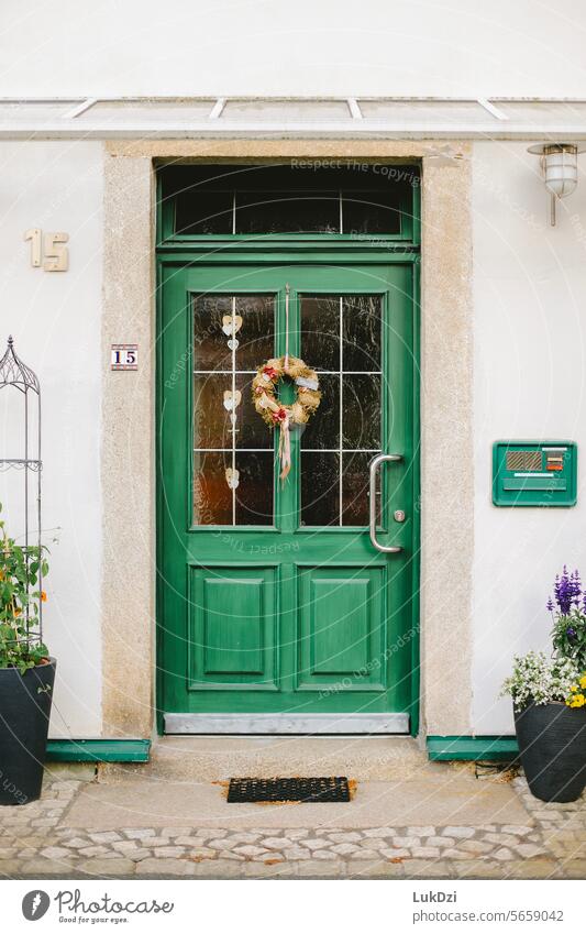 Photo of a classic wooden green front door to a building on a sunny day with no people Wooden door Old Entrance Front door Building Turquoise Main gate Way out