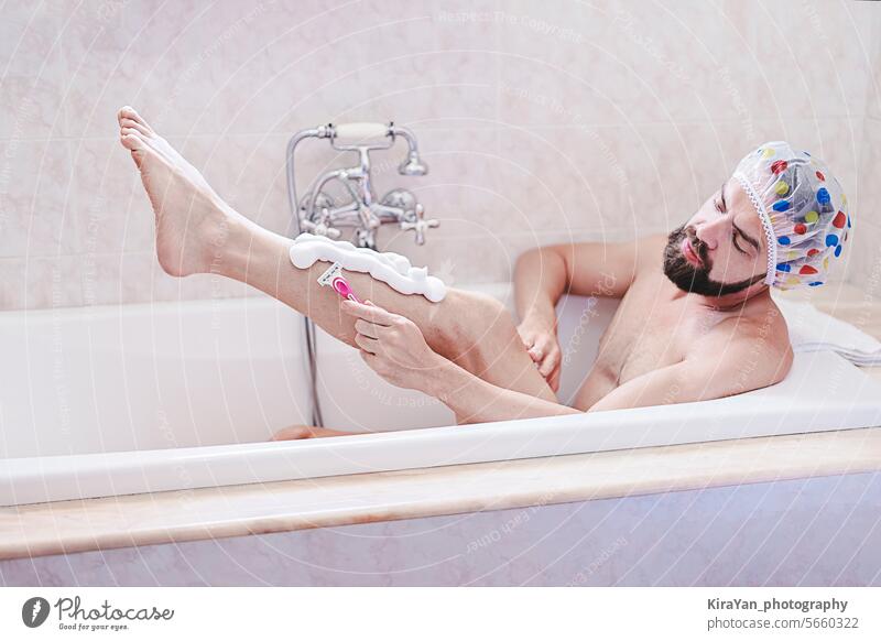 Bearded man in shower cap relaxes with shave in bath time. Skin and self-care concept, men's health is matters beard hygiene shaving mens health bathtub