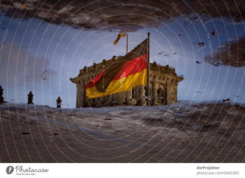 Reichstag in the reflection of a puddle with the German flag metropolis Freedom City Berlin center Panorama (View) Sunbeam urban Beautiful weather City life