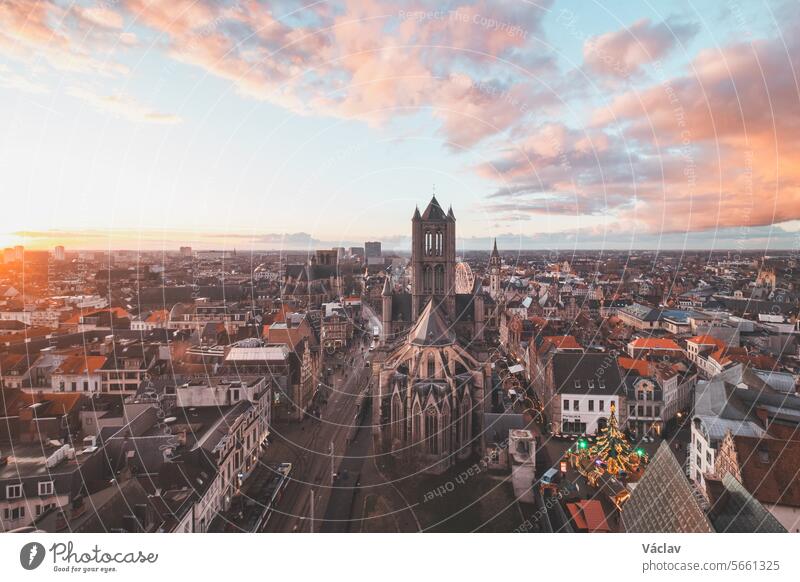 Watching the sunset over Ghent from the historic tower in the city centre. Romantic colours in the sky. Red light illuminating Ghent, Falnders region, Belgium